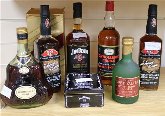Six assorted whiskies, Jack Daniels, Jim Beam and two cognacs